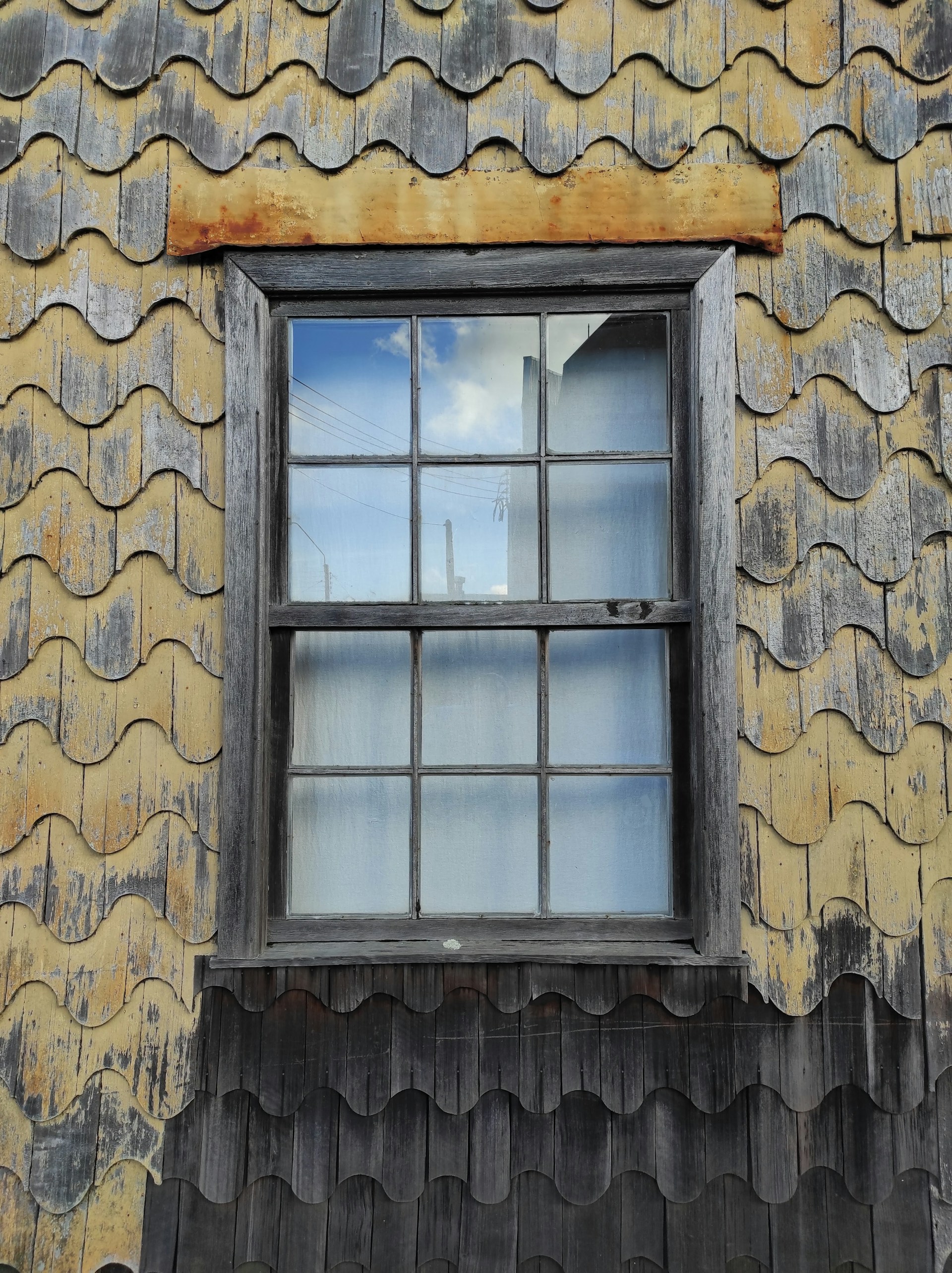 a window on a building with a sky in the background