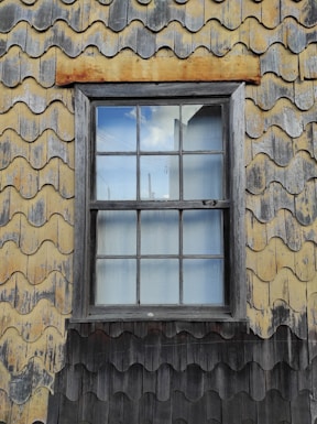 a window on a building with a sky in the background