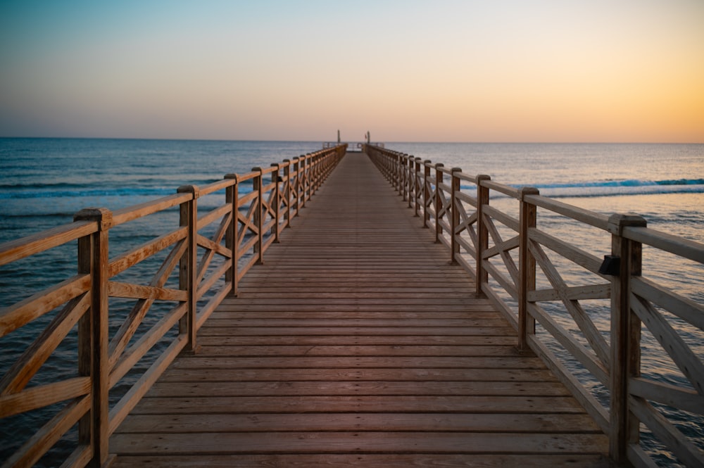 a long wooden pier stretches out into the ocean