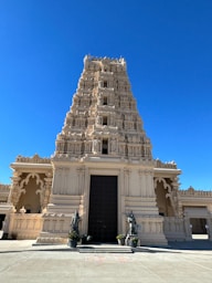 a tall white building with a black door