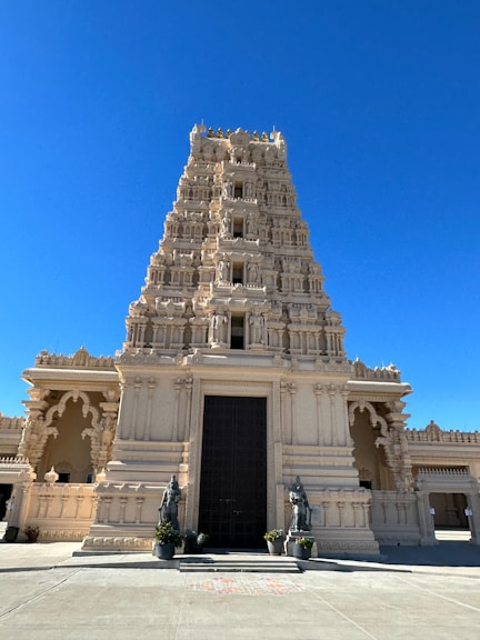 a tall white building with a black door