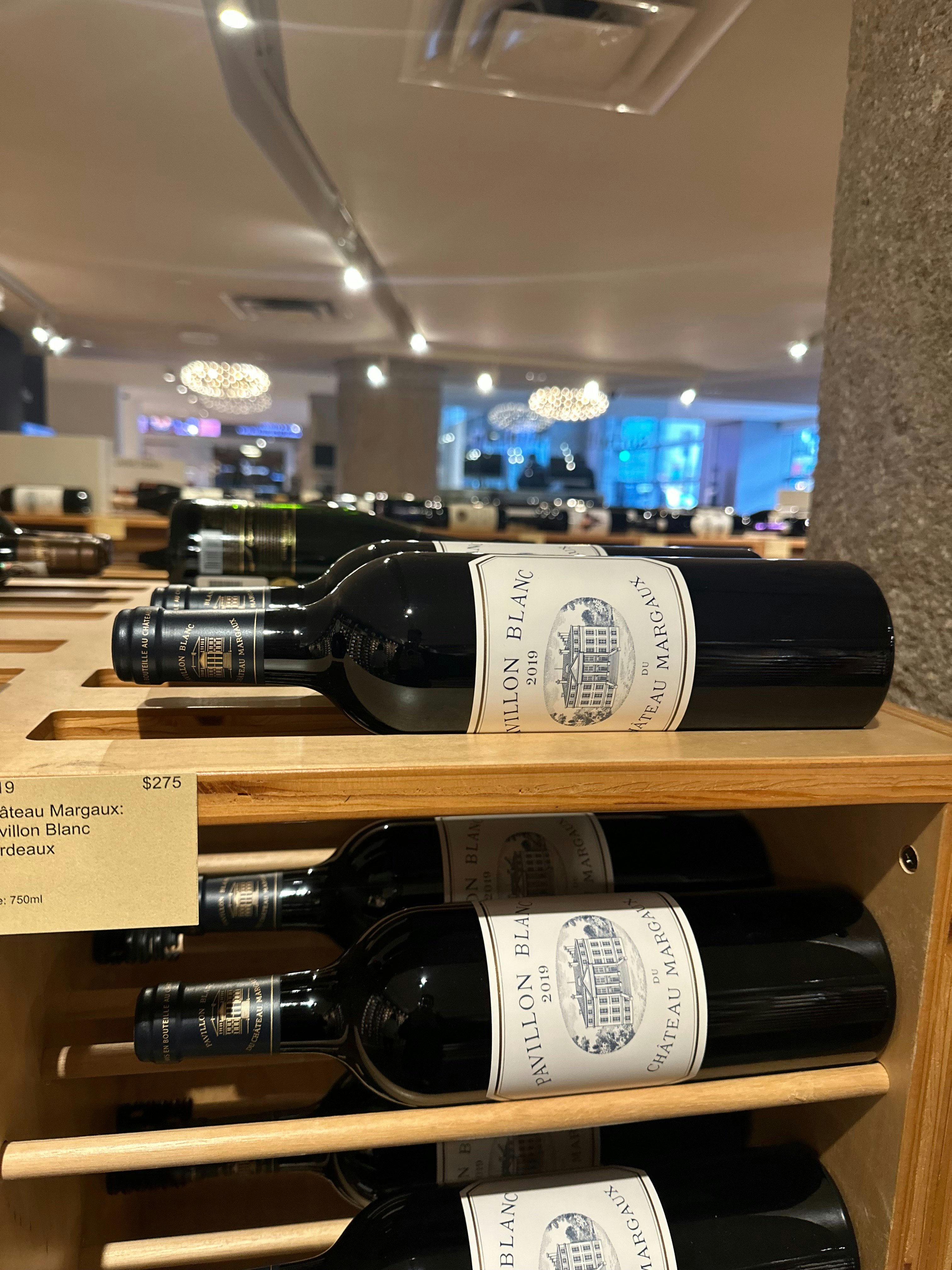 a bunch of bottles of wine on a shelf