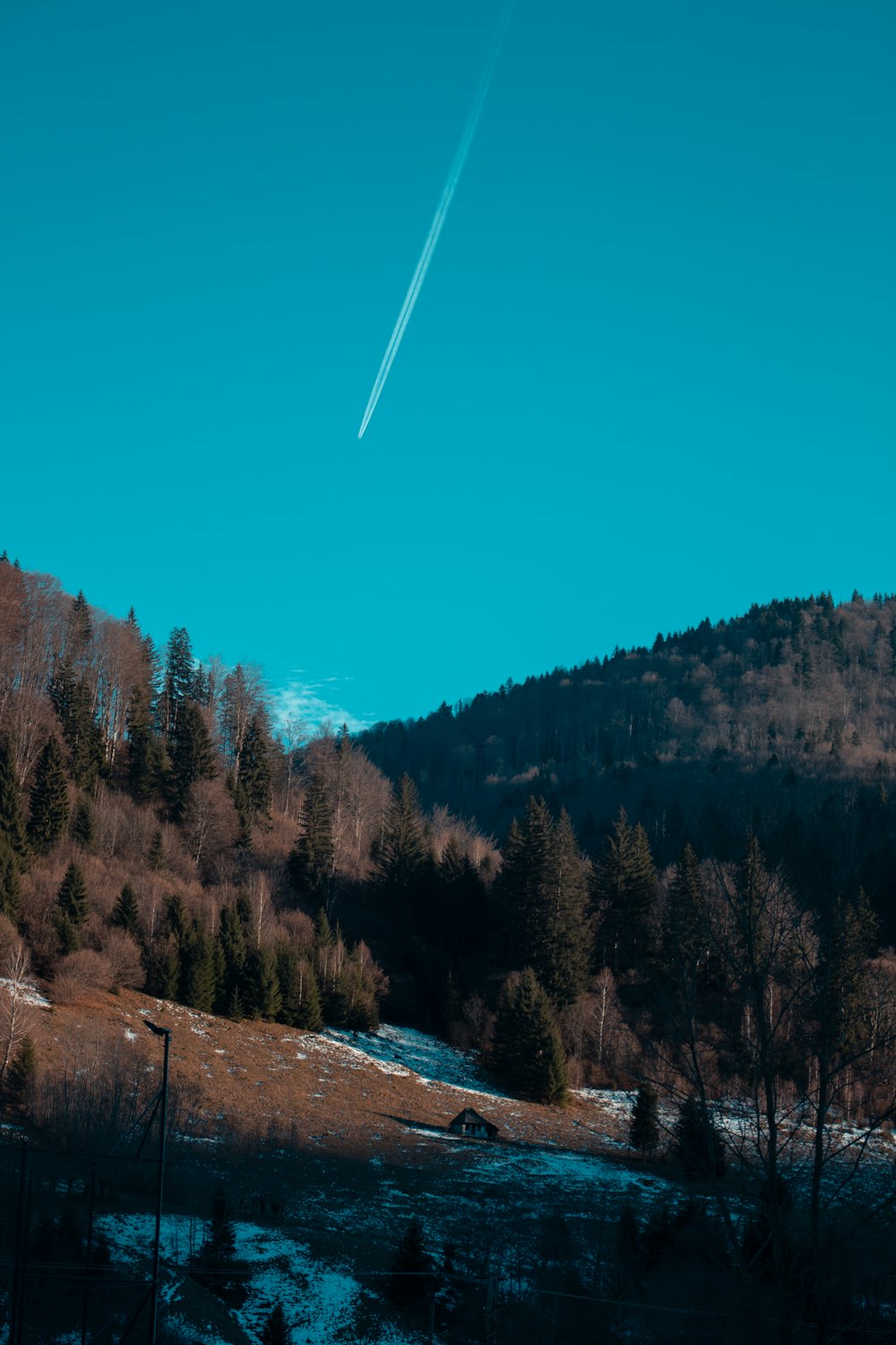 a plane is flying over a snowy mountain