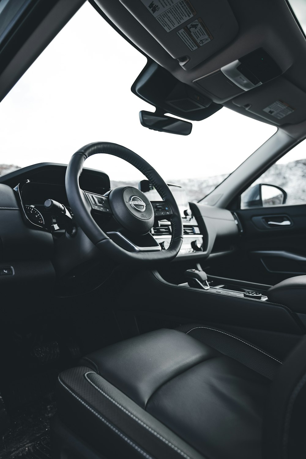 the interior of a car with a steering wheel and dashboard