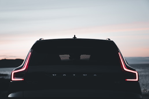 the back end of a car with its lights on