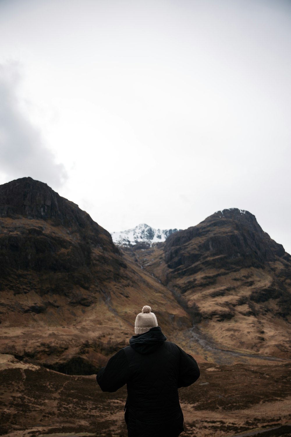 a person standing in front of a mountain