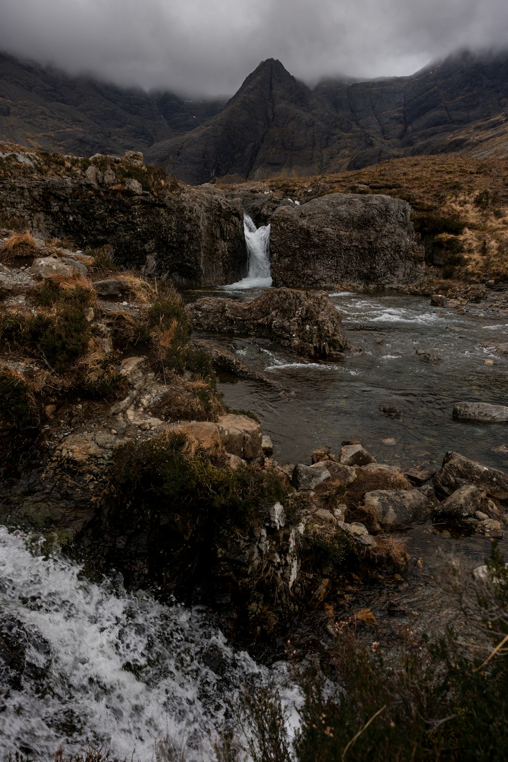 a small waterfall in the middle of a mountain