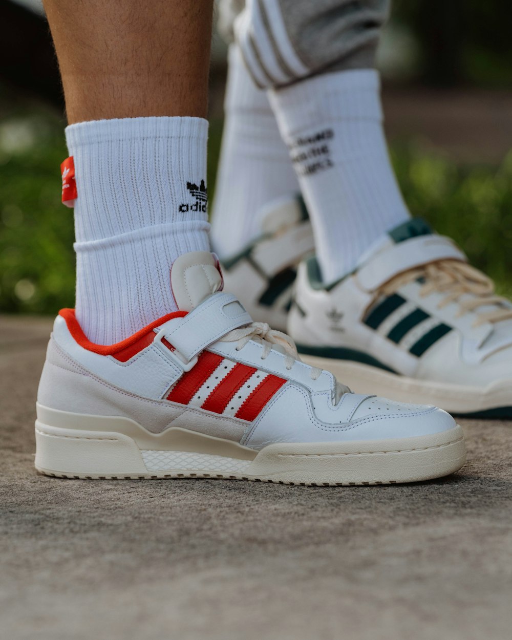 a close up of a person wearing adidas shoes