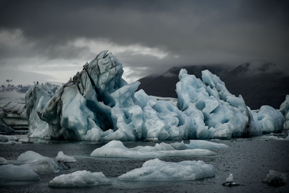 a group of icebergs floating on top of a body of water