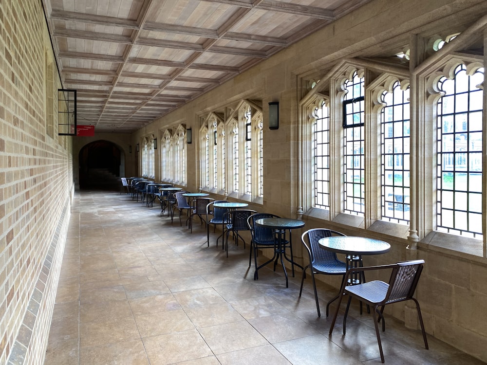 a long row of tables and chairs in a room