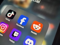 a close up of a cell phone with social icons on it