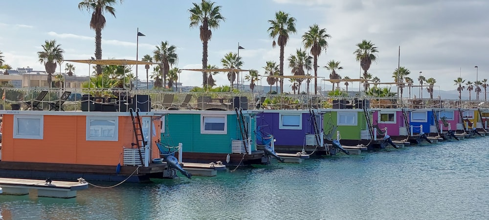 a row of colorful houses sitting on top of a body of water