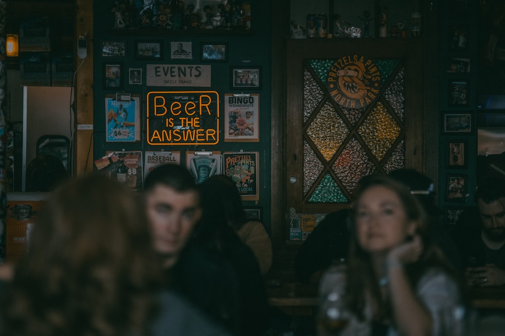 a group of people sitting around a bar