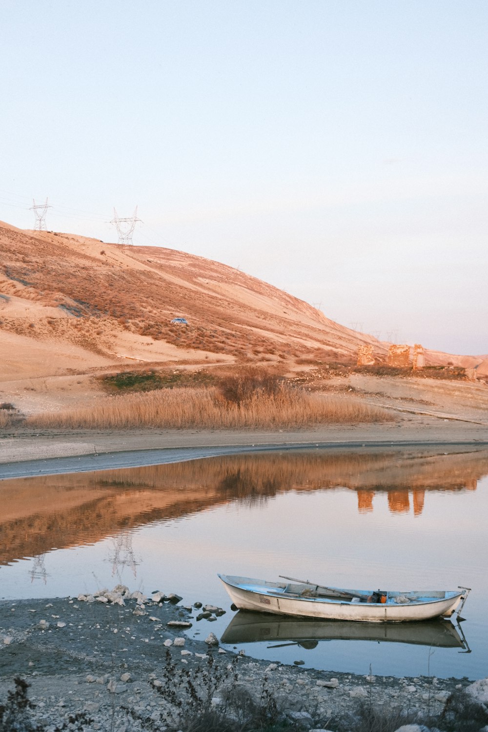 a small boat floating on top of a lake