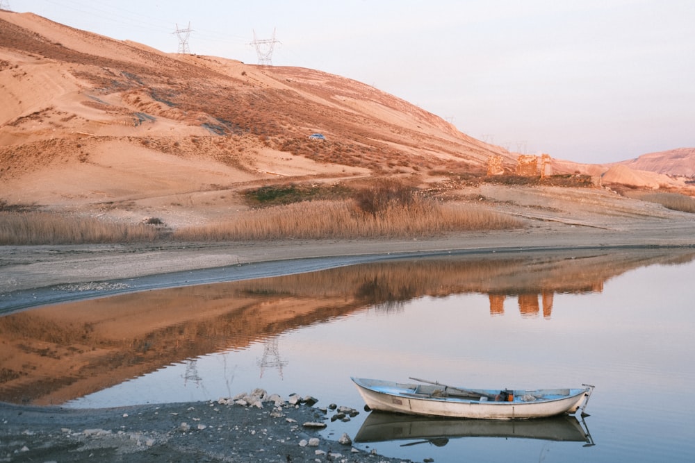 a small boat sitting on top of a lake