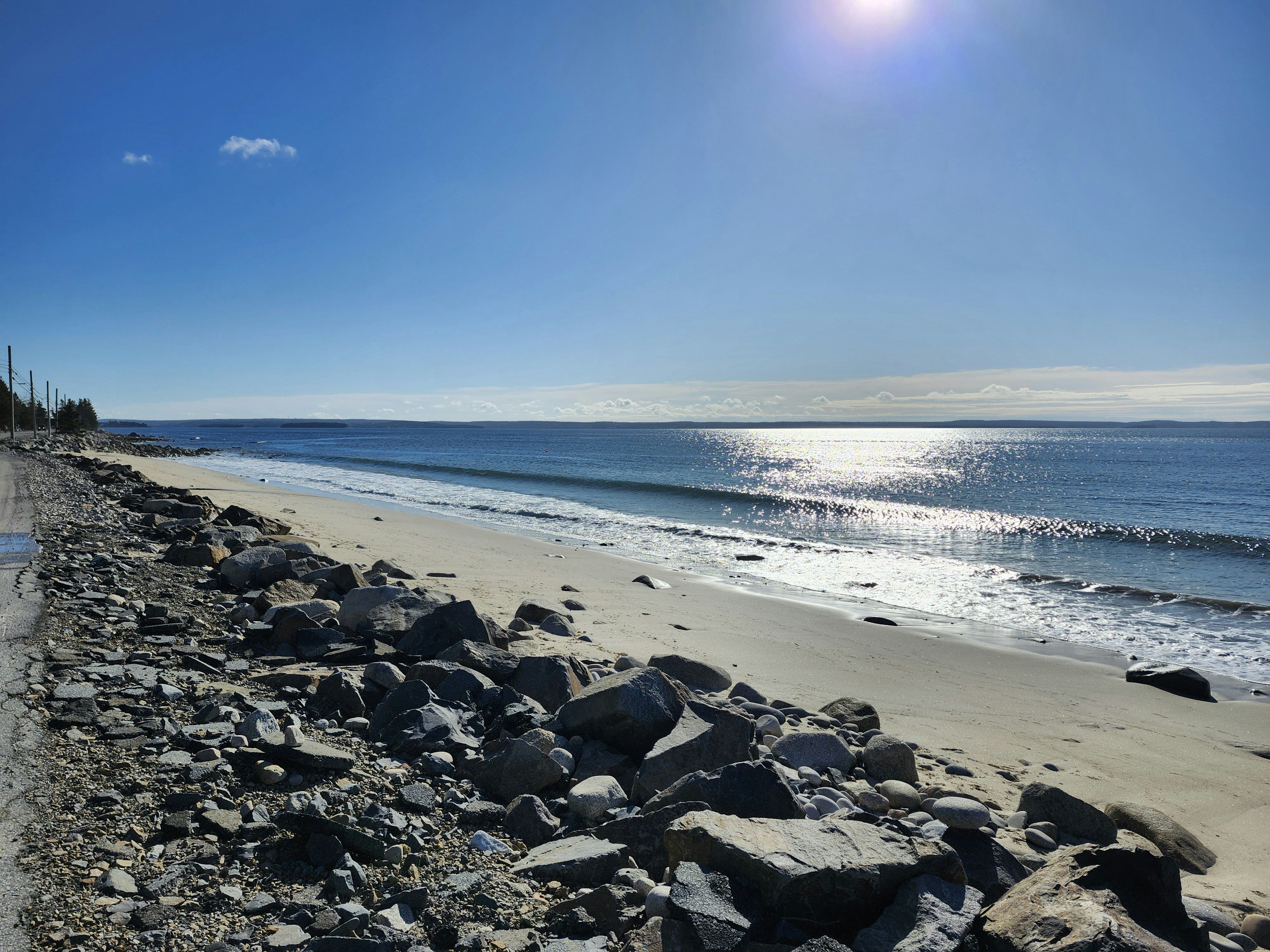 a view of a beach with rocks and water