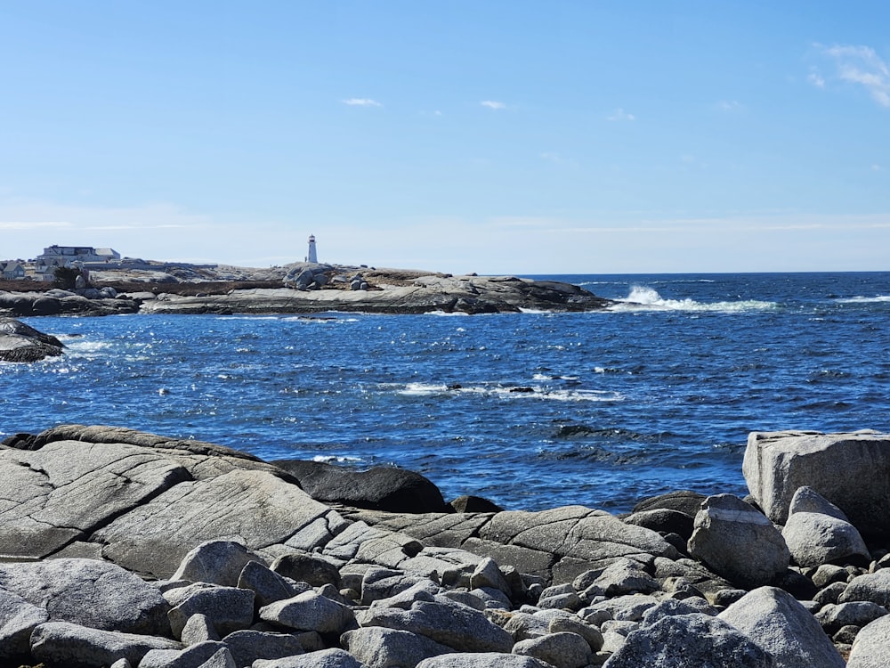 a lighthouse on a rocky shore near the ocean