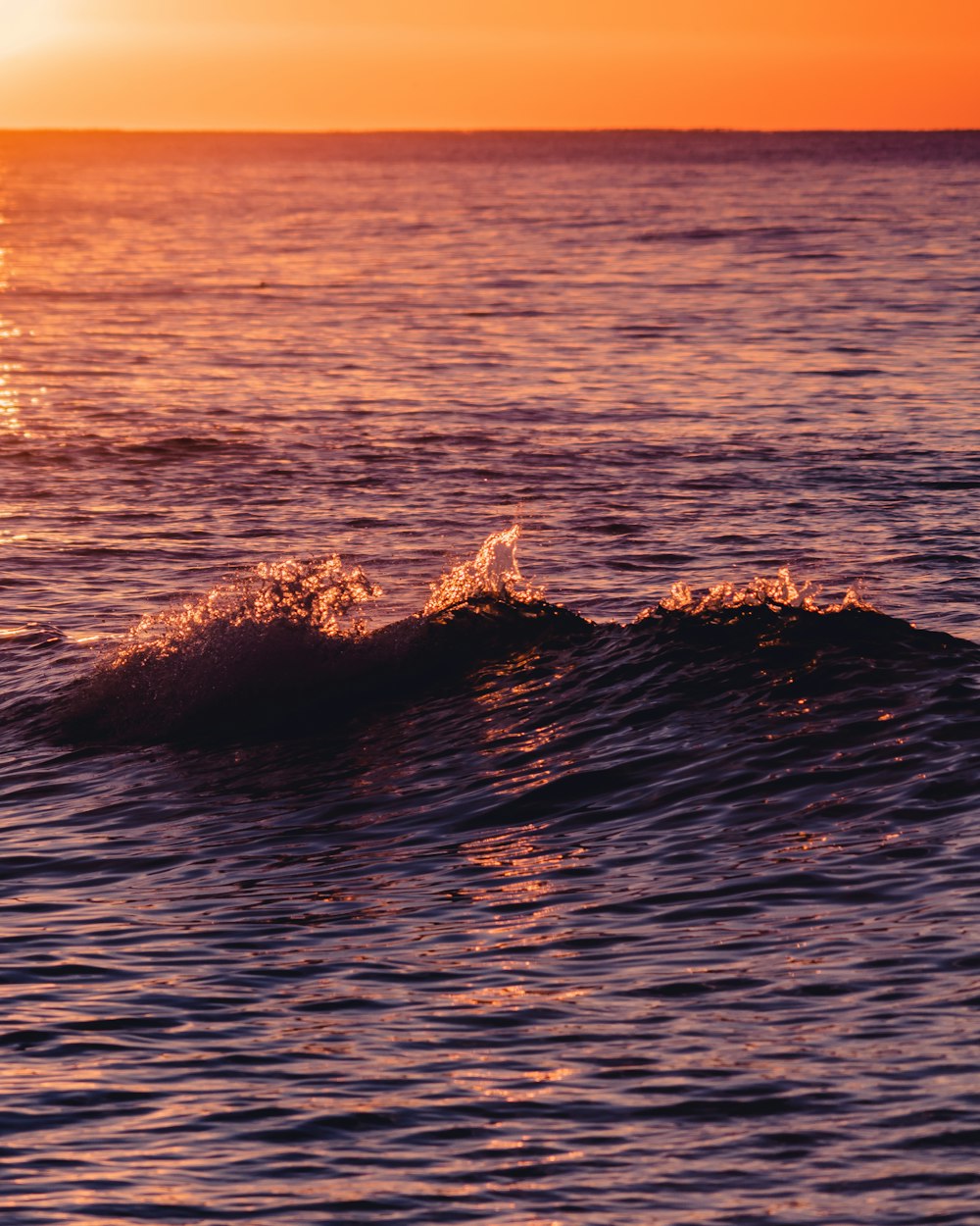 a person riding a surfboard on a wave in the ocean