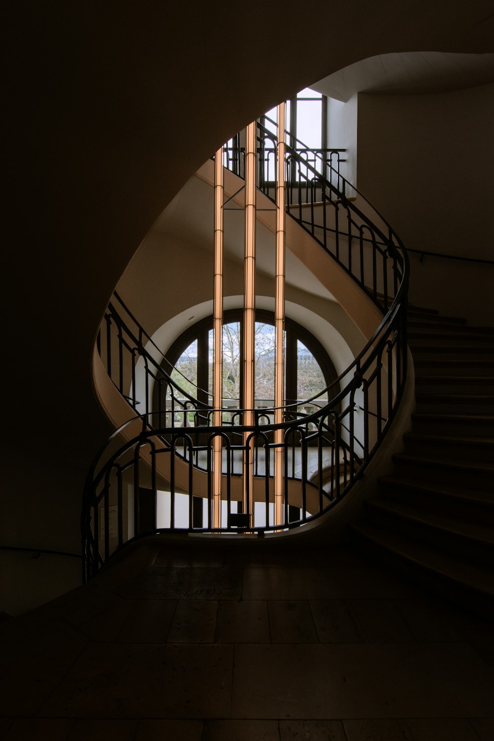 a spiral staircase in a building next to a window