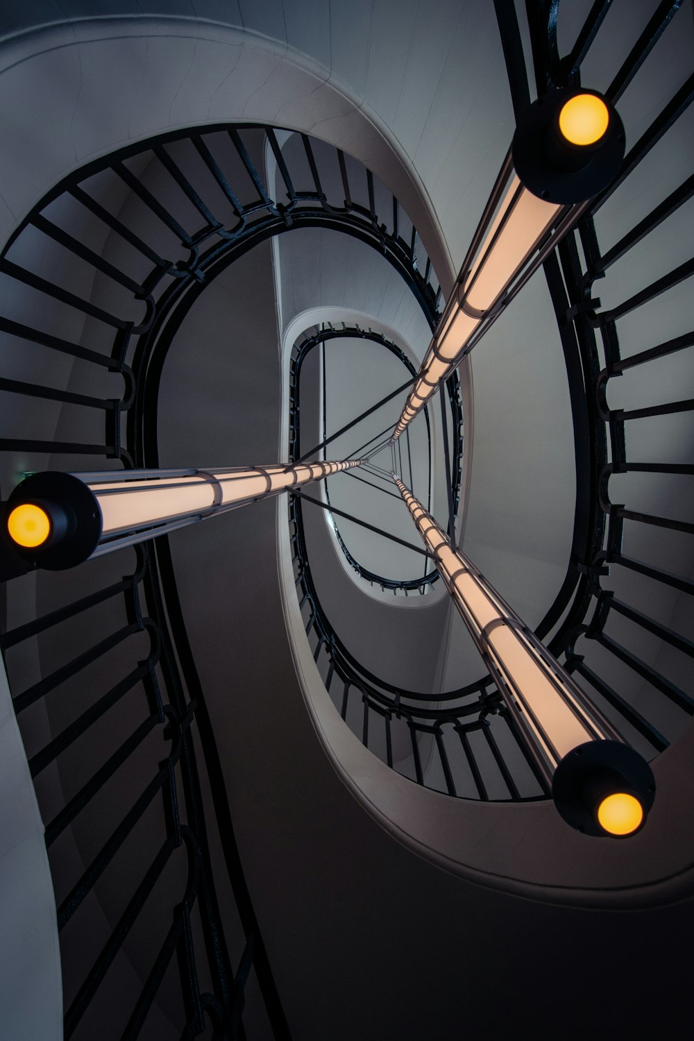 a spiral staircase with three lights on each of it