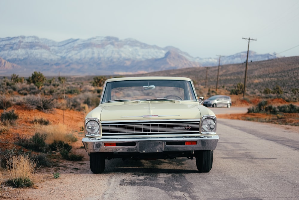 an old car parked on the side of the road