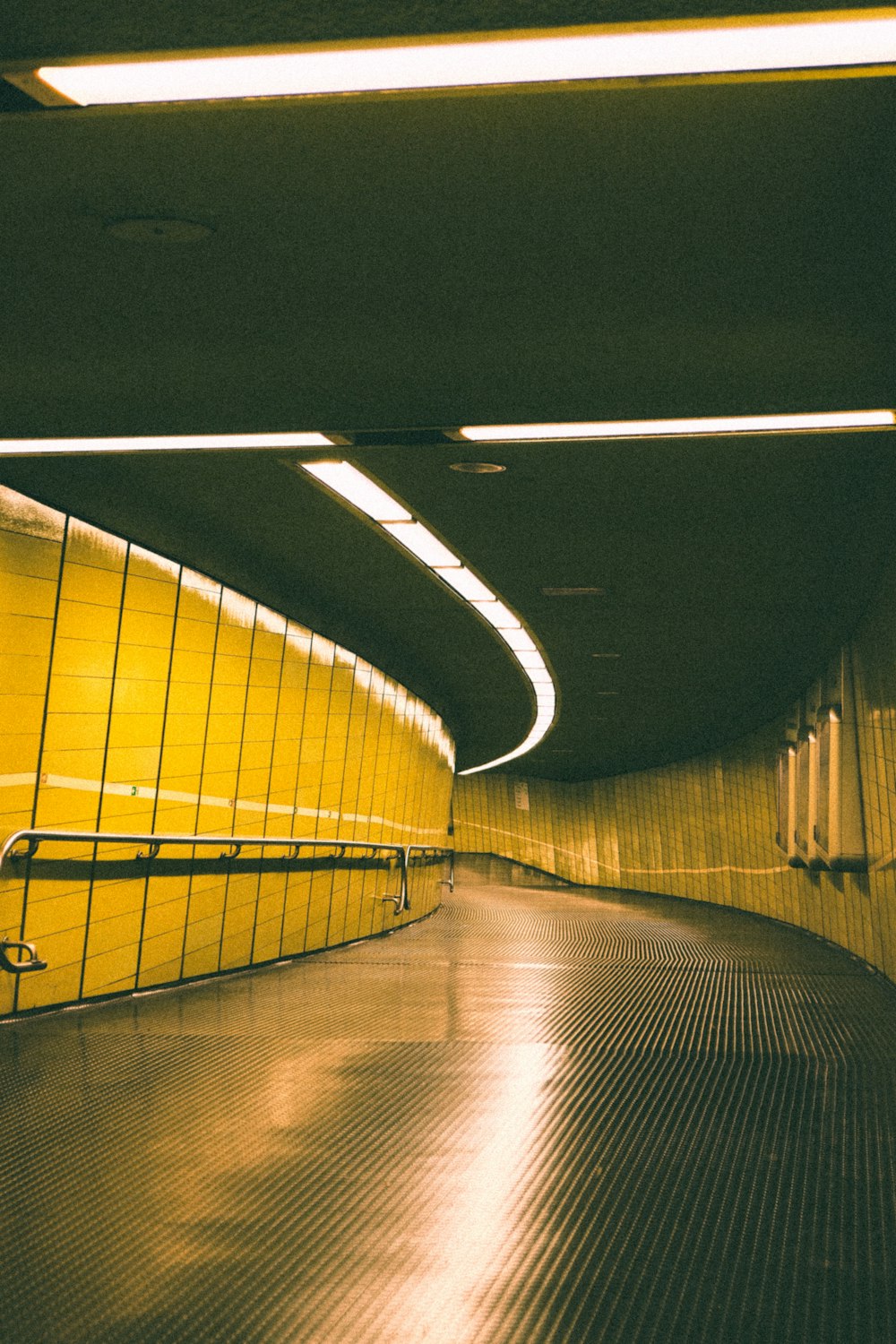 a yellow tunnel with a bench in the middle of it
