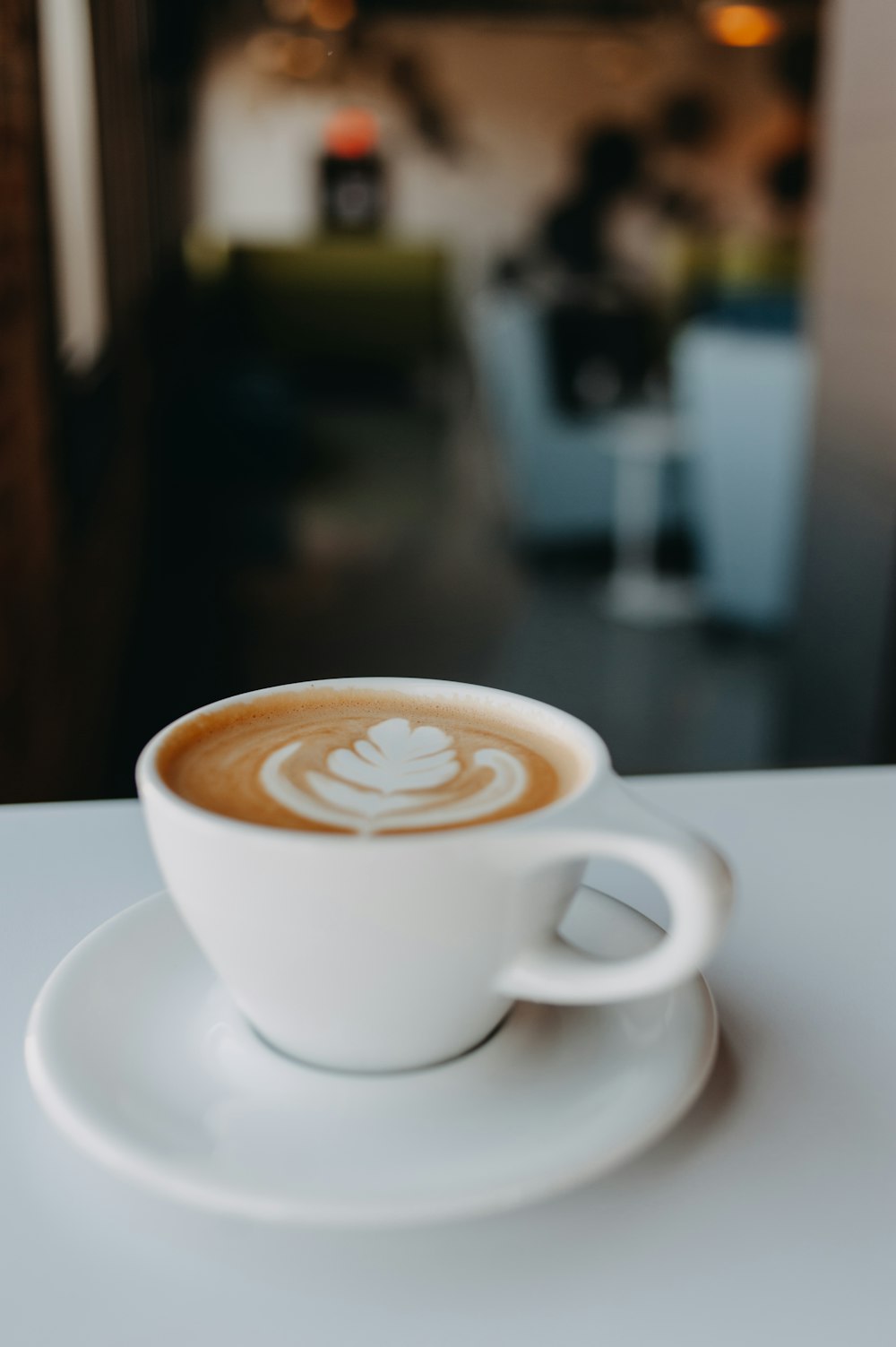 a cup of coffee on a saucer on a table