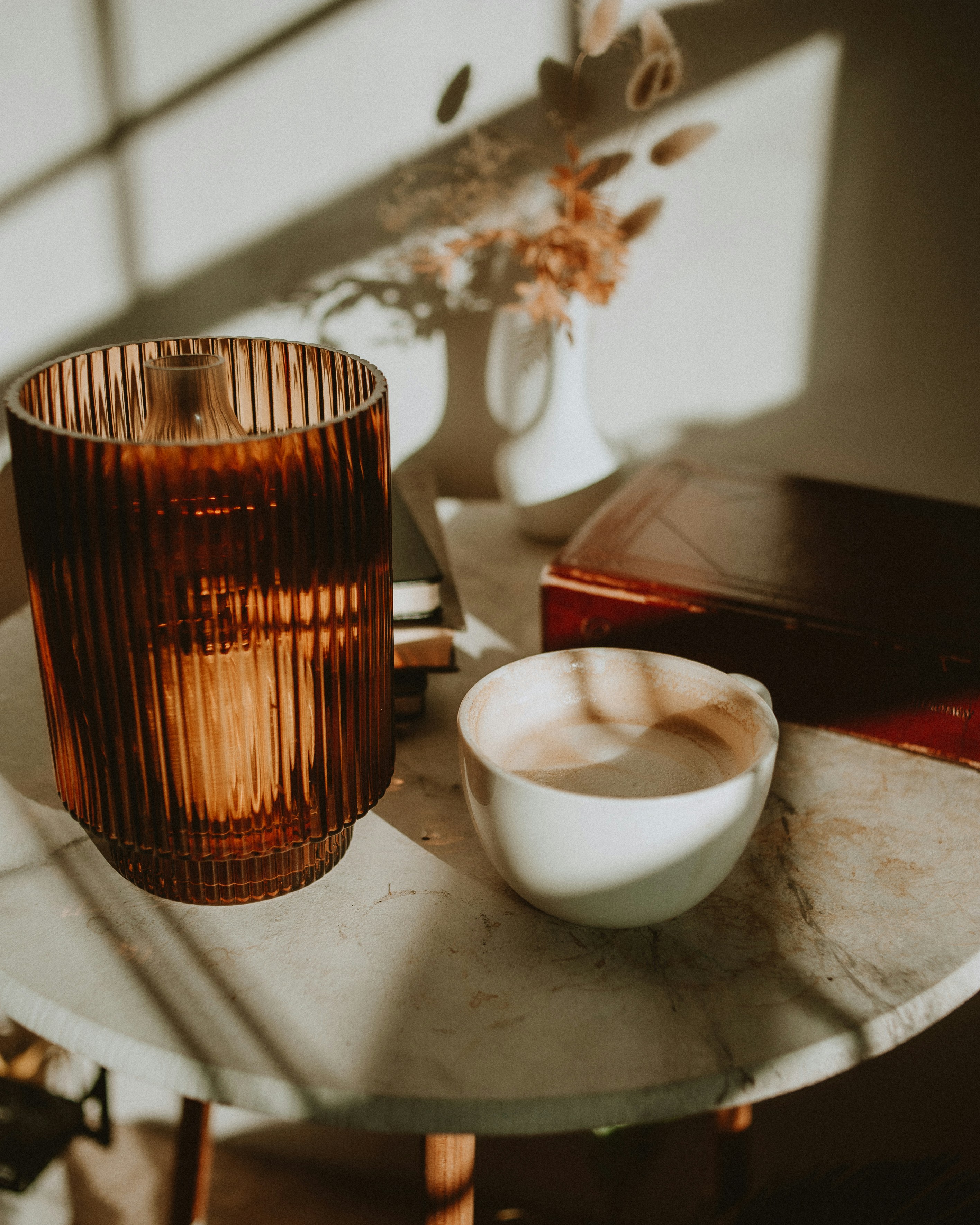 a table with a vase and a bowl on it