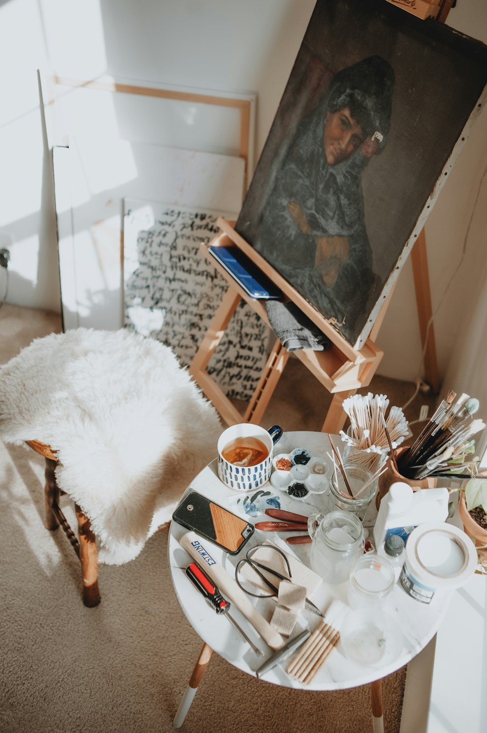 a table with a painting and other items on it