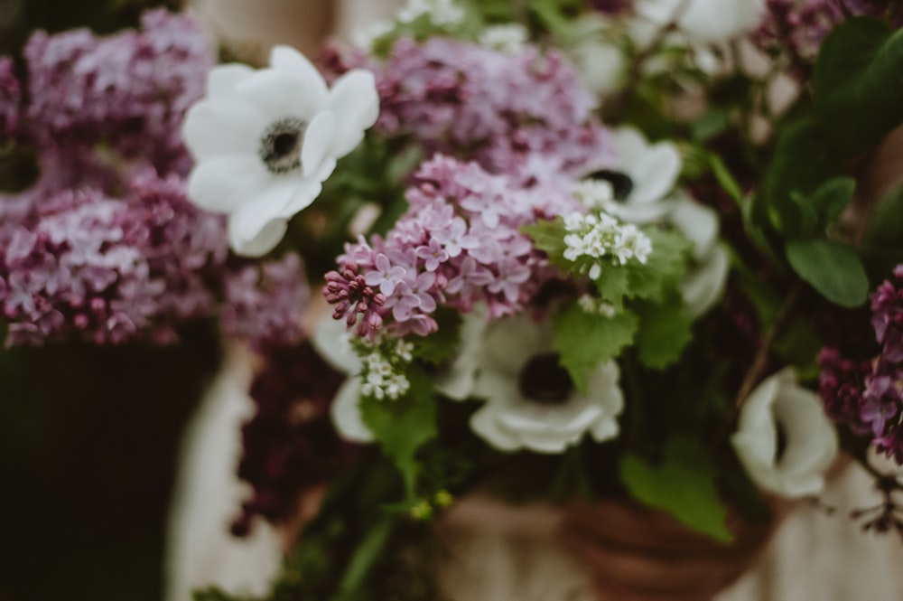 a woman holding a bouquet of flowers in her hands