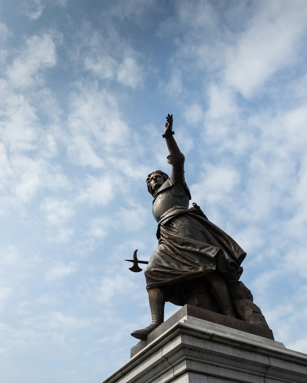 a statue of a man holding a bird in his hand