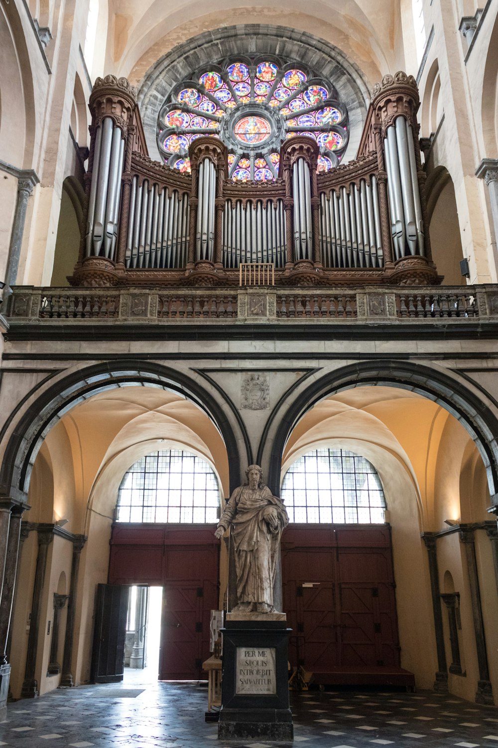 a large cathedral with a pipe organ and a statue