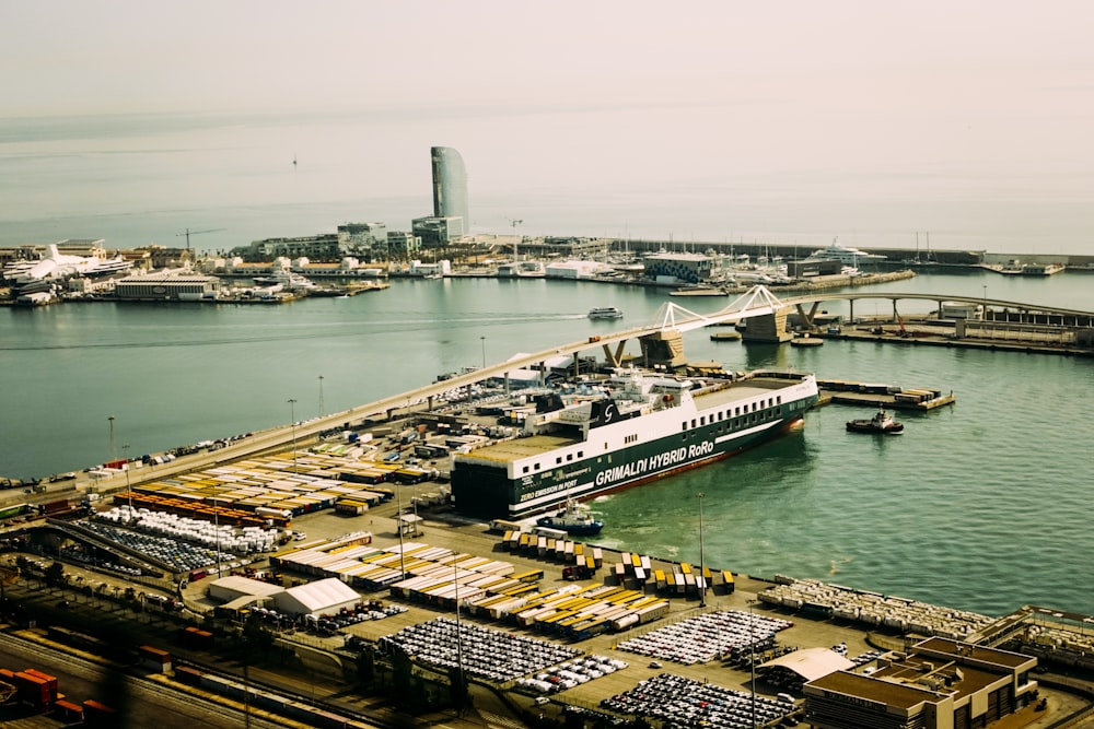 a large boat docked in a harbor next to a bridge