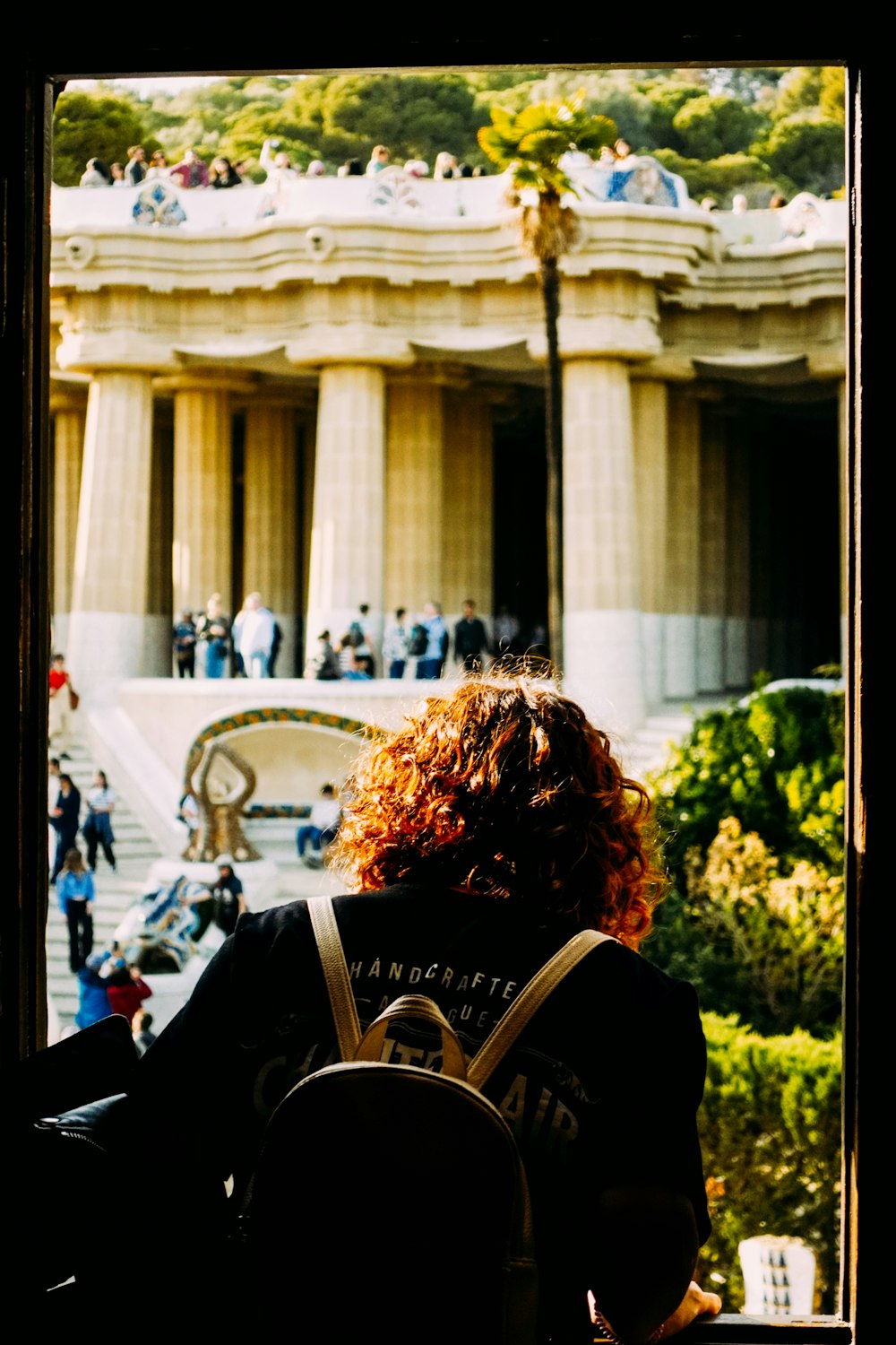 a person with a backpack looking out a window