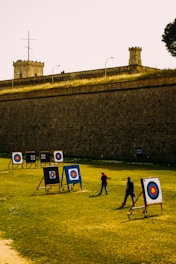 a group of people standing on top of a lush green field