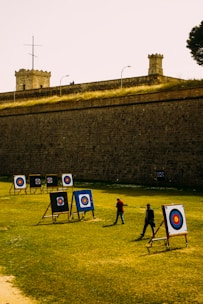a group of people standing on top of a lush green field