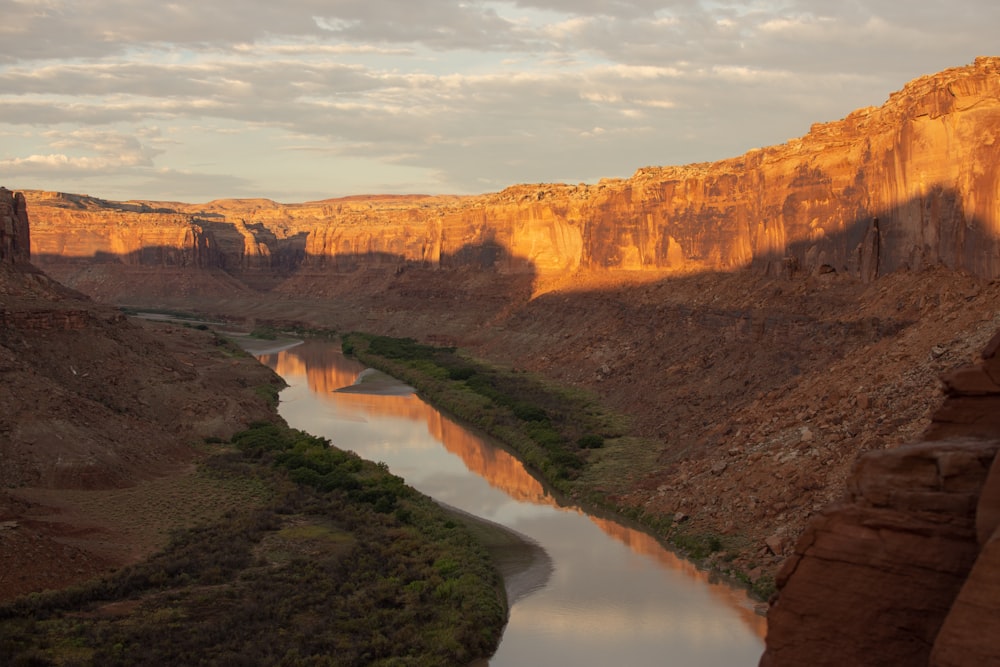 a river running through a canyon surrounded by mountains