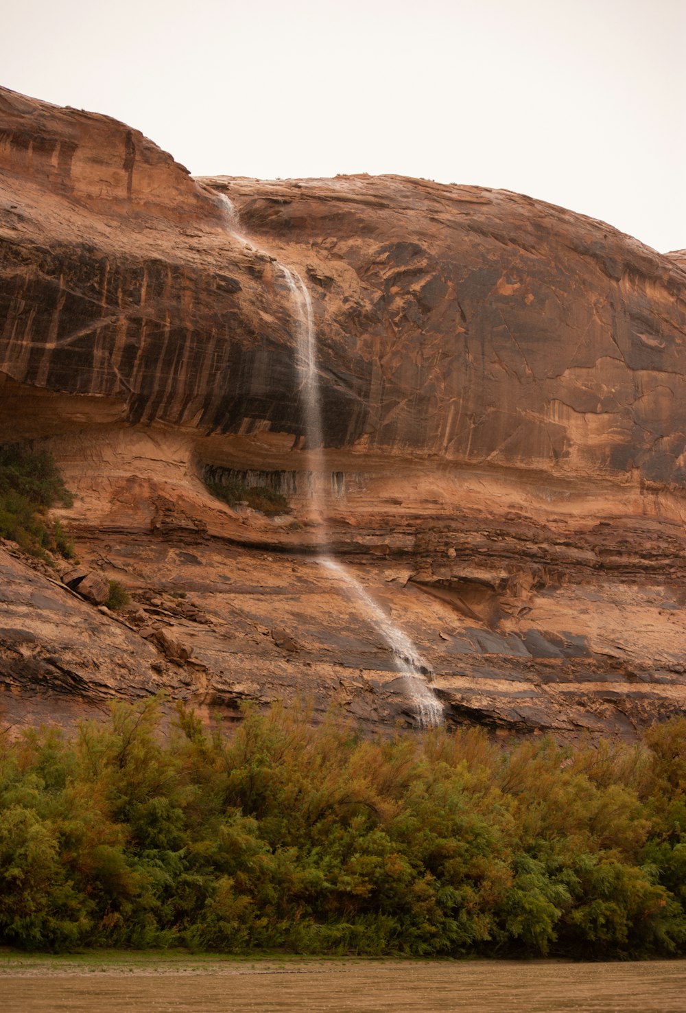 a waterfall cascading from a cliff into a body of water