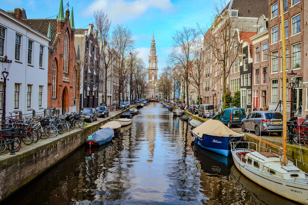 a canal with boats and bicycles on both sides of it