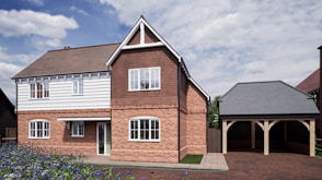 a two story brick house with a garage