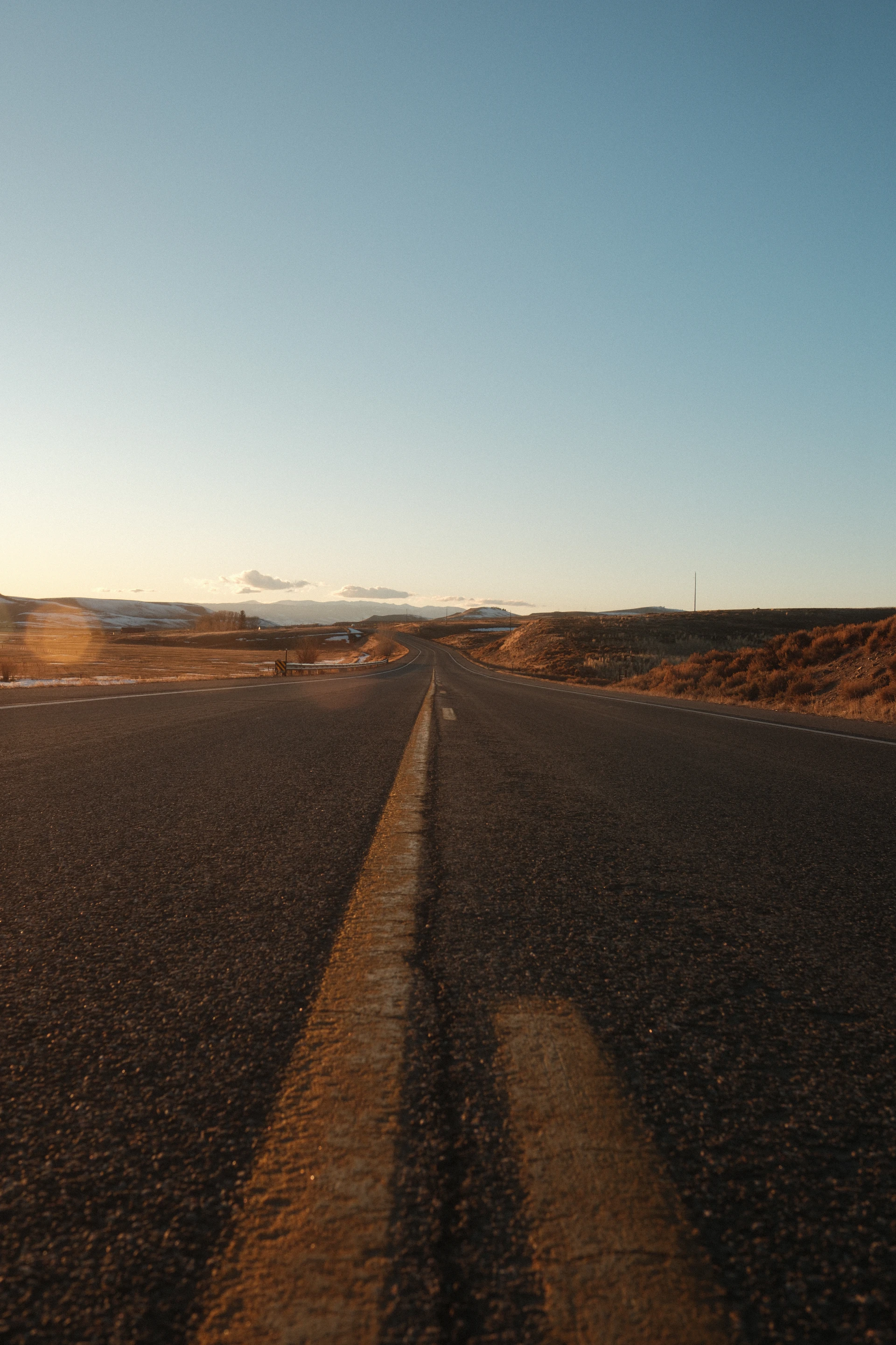 an empty road in the middle of the desert