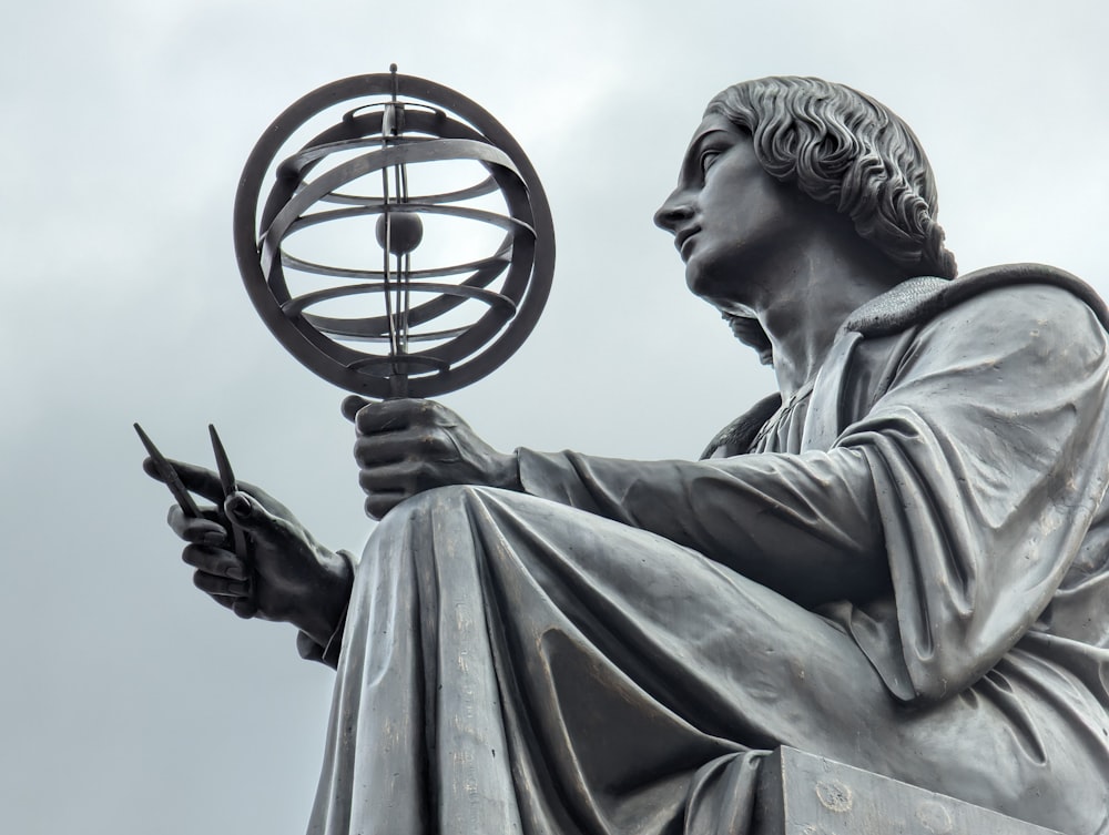 a statue of a man holding a globe