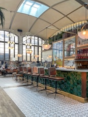a restaurant with chairs and a bar in the middle of the room