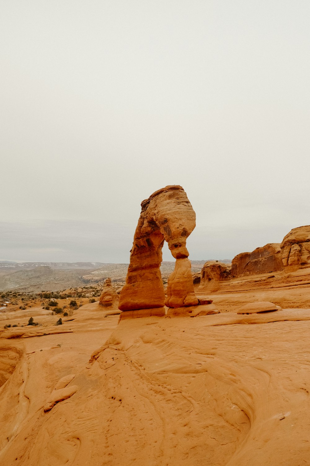 a large rock formation in the middle of a desert