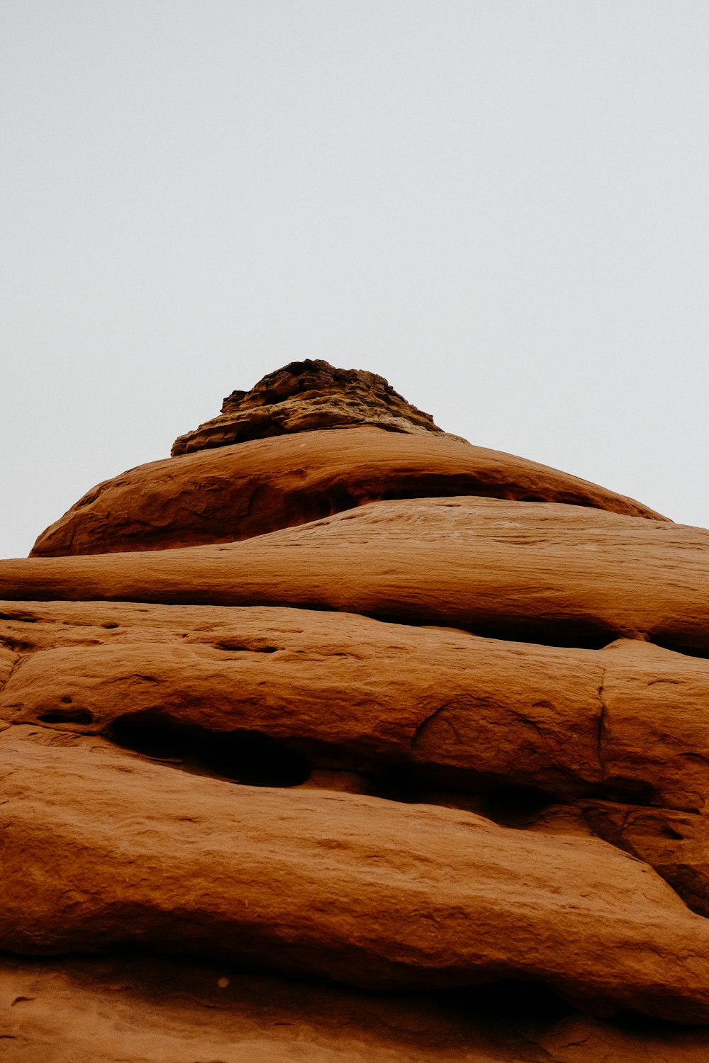 a bird is perched on top of a rock formation