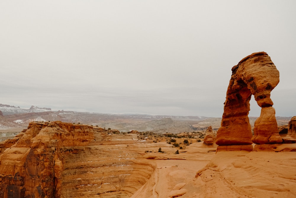 a large rock formation in the middle of a desert