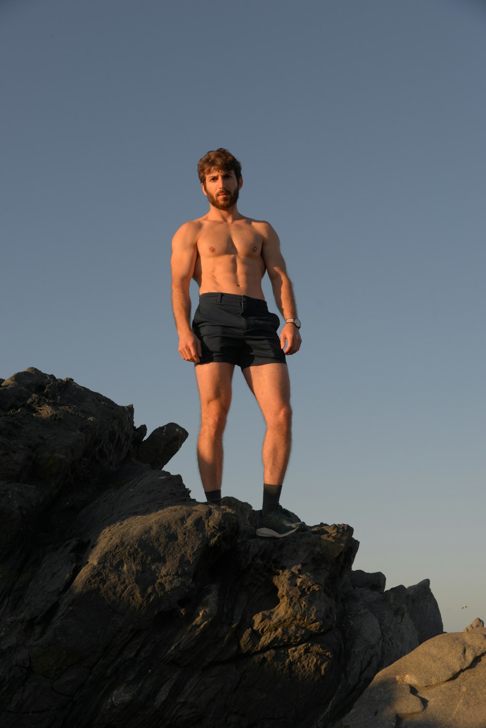 a man standing on top of a rocky cliff