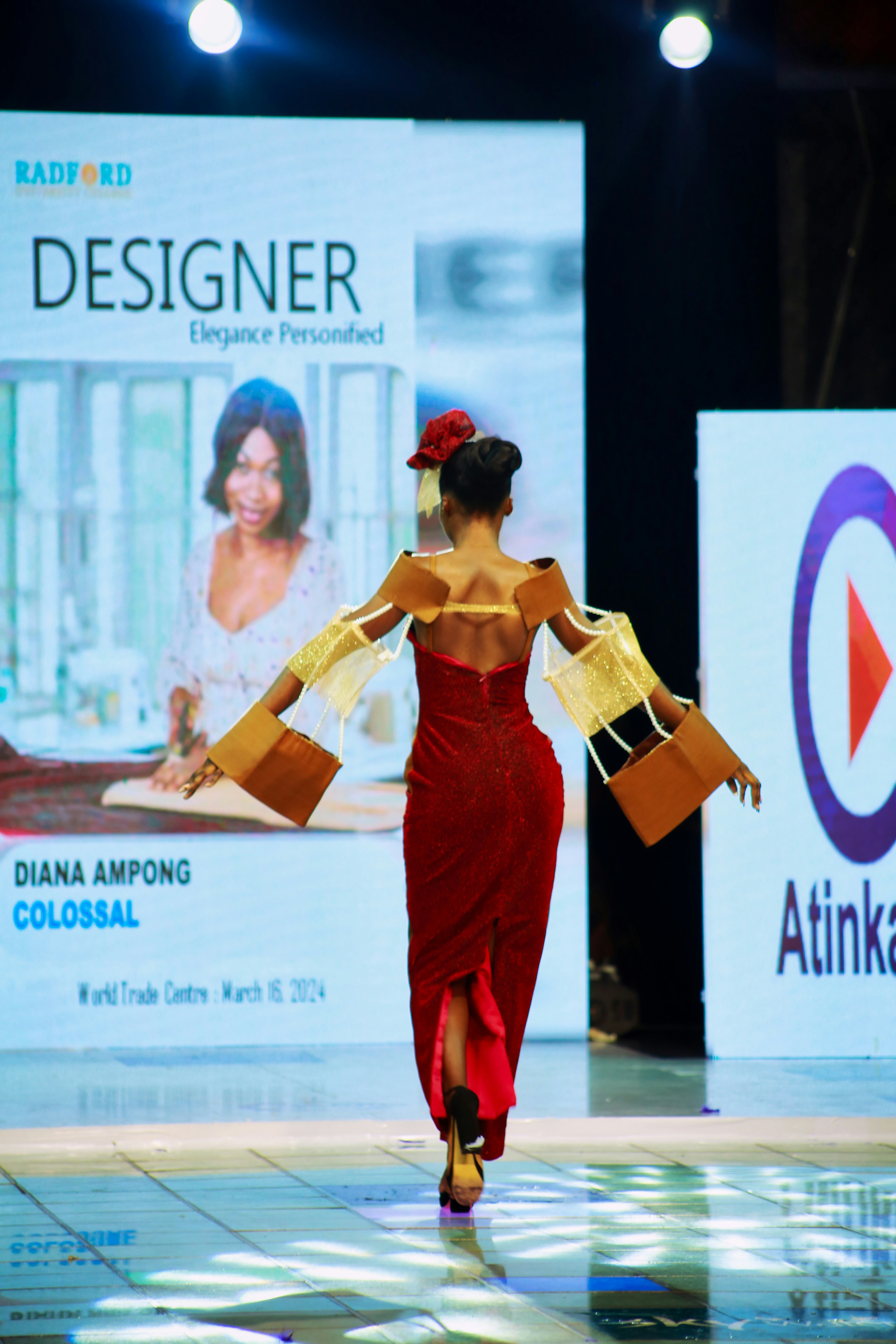 Models on runway in avant-garde fashion under dramatic white spotlights, sleek modern venue
