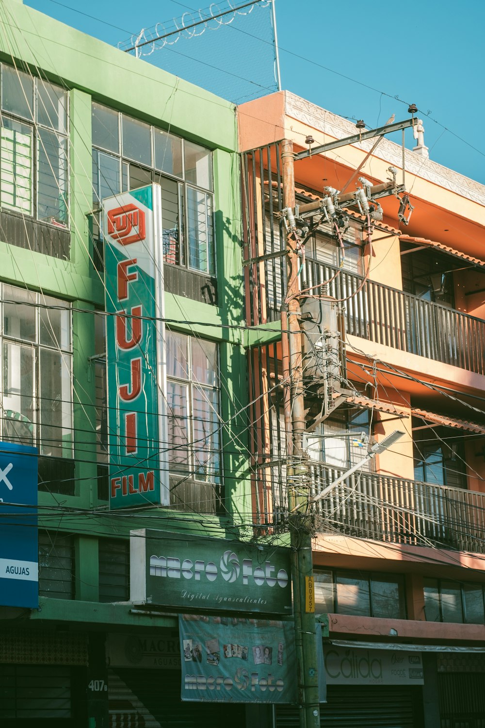 a green building with a neon sign on the side of it