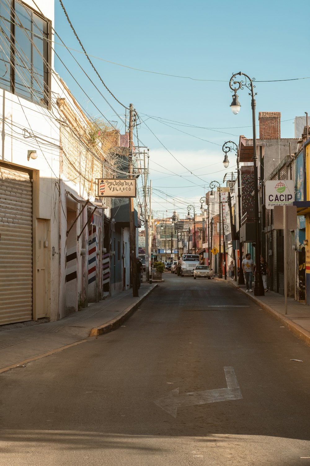 a city street with a car parked on the side of it